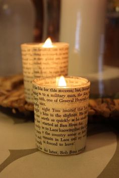 two lit candles sitting on top of a table