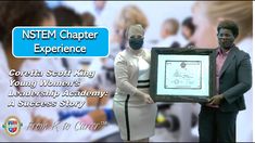 two women holding up a framed poster with words on it and the caption reads, nstem charter experience coretta scott king young's