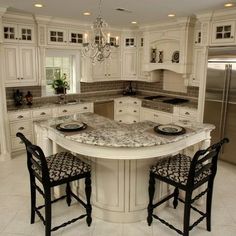 a kitchen with an island and two chairs