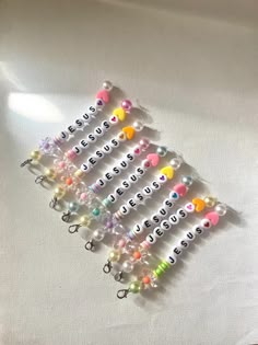 a bunch of beads that are sitting on a white tablecloth with the word nerd spelled in small letters