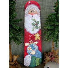 a christmas stocking with santa claus on it and other decorations next to a tree