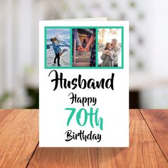 a greeting card with two photos and the words husband happy 70th birthday on it, sitting on a wooden table