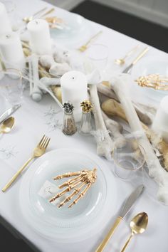 the table is set with gold and white decorations