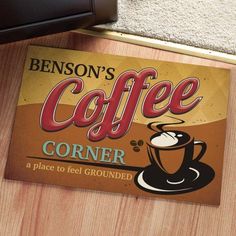 a close up of a coffee sign on a wooden floor with carpeting and rugs