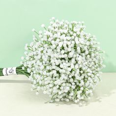 a bouquet of white flowers sitting on top of a table