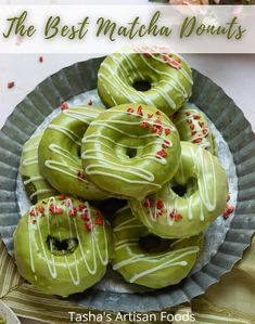 green donuts with white glaze and sprinkles on a plate