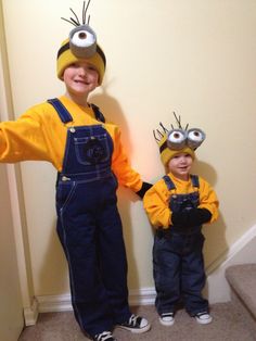 two young boys dressed up as minions from the movie despicables standing next to each other