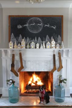 a fireplace decorated with christmas decorations and stockings