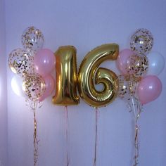 balloons and streamers in the shape of the number six are arranged against a wall