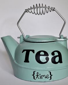 a tea kettle with the words tea time written on it