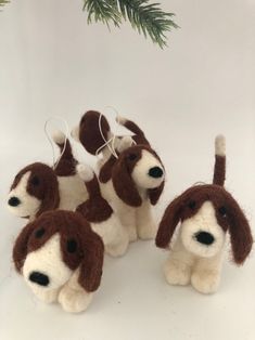 four brown and white stuffed dogs sitting next to each other