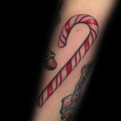 a candy cane tattoo on the arm