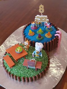 a birthday cake that looks like it is made to look like an animal farm scene