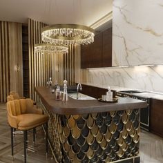 an elegant kitchen with gold accents and marble counter tops, along with bar stools