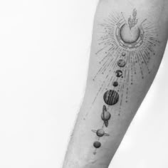 a man's arm with planets and sun on it