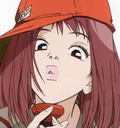 a girl with red hair wearing a baseball cap and holding a cell phone in her hand