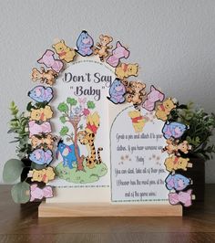 a winnie the pooh baby book with flowers and leaves around it on a table