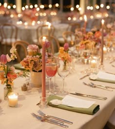 the table is set with candles, flowers and menus for an elegant wedding reception