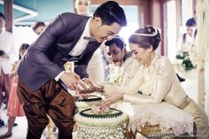 a bride and groom cutting their wedding cake