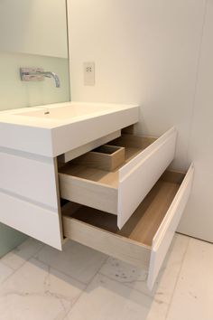 a bathroom vanity with two drawers and a mirror