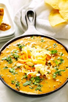 a bowl of soup with tortilla chips on the side