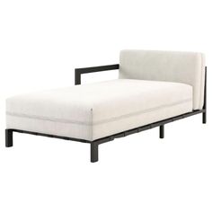 a white chaise lounge chair with black legs