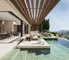 an outdoor living area with pool and lounge chairs