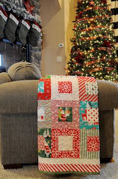 a living room filled with furniture and a christmas tree in the backgroung