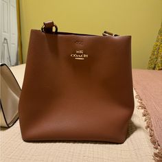 Like New Condition Elegant Cognac Bucket Bag For On-the-go, Cognac Bucket Bag With Dust Bag Included, Coach Luxury Bucket Bag For Everyday, Coach Cognac Top Handle Bag, Coach Top Handle Bag In Cognac, Classic Coach Crossbody Bucket Bag, Coach Bucket Bag With Double Handle, Coach Everyday Bucket Bag, Luxury Coach Bucket Bag For Everyday