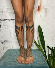 a woman's legs with tattoos on them