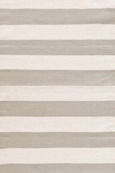 an area rug with grey and white stripes