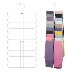 several pairs of colorful pants hanging on a clothes rack next to a white hanger