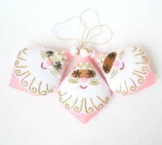 an ornament shaped like a cat with pink and white fur on it's back