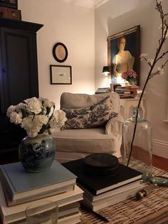 a living room filled with lots of furniture and books on top of a coffee table