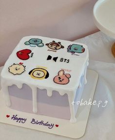 a birthday cake with many stickers on it