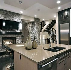 a kitchen with an oven, sink and television on the wall in it's center island