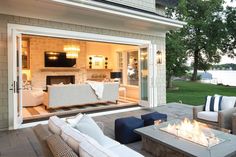 a fire pit sitting on top of a patio next to a living room filled with furniture