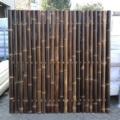 a tall bamboo fence is shown in front of some pallets