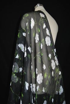 a black and white floral print scarf on a mannequin's dummy head