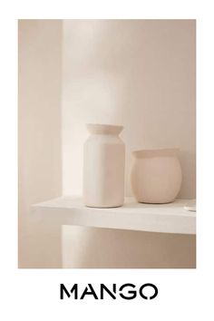 a white vase sitting on top of a shelf