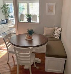 a table and bench in a small room