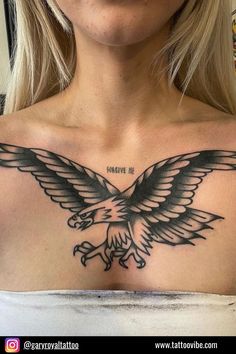 a woman with a tattoo on her chest has an eagle and the words give me