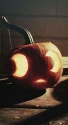 two carved pumpkins sitting next to each other