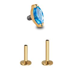 two gold posts with blue crystal stone in the center and an earring on each side