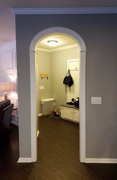 an open doorway leading to a bedroom and bathroom