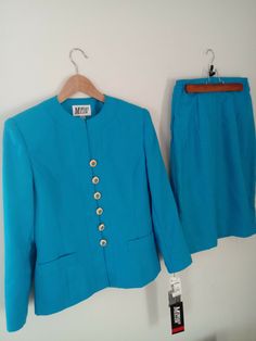 New with Tag Beautiful Size:8 Blue Morgan Miller 2-piece Skirt Suit RN# 35642 Made in China This beautiful suit is 65% POLYESTER AND  35% RAYON, and is fully lined. The jacket has a DECORATIVE pocket on each side. The skirt has a hidden zipper and a button in the back. There is partial elastic on each side of the waist. Measurements: Jacket: Shoulders (shoulder-to-shoulder), Approx.: .......17" Chest (pit-to-pit), Approx.: ...................................20"   Length, Approx.: ............... Fitted Blue Sets With Pockets, Fitted Vintage Blue Set, Fitted Blue Two-piece Sets, Blue Fitted Vintage Set, Blue Two-piece Set For Workwear, Classic Blue Long Sleeve Skirt Suit, Blue Long Sleeve Classic Skirt Suit, Vintage Blue Long Sleeve Sets, Blue Buttoned Set For Spring