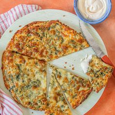 a cheese pizza cut into four slices on a plate