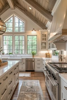 a large kitchen with white cabinets and wood floors, along with an area rug on the floor