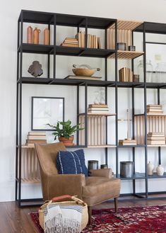 a living room filled with furniture and bookshelves on top of eachother