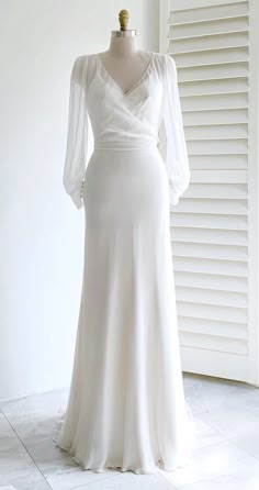 a white dress on display in front of a window